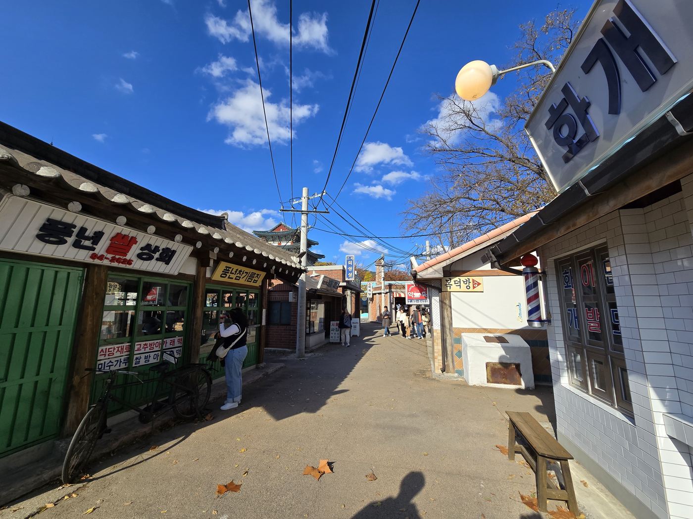 outdoor 1970s folk village street, warm light