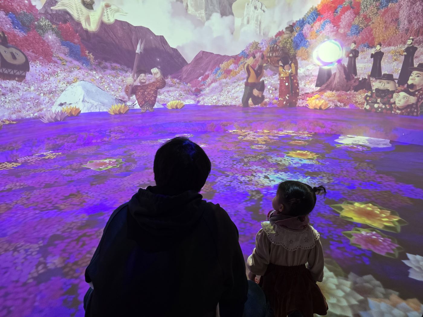 immersive projection room, floor and walls lit with Korean folklore imagery