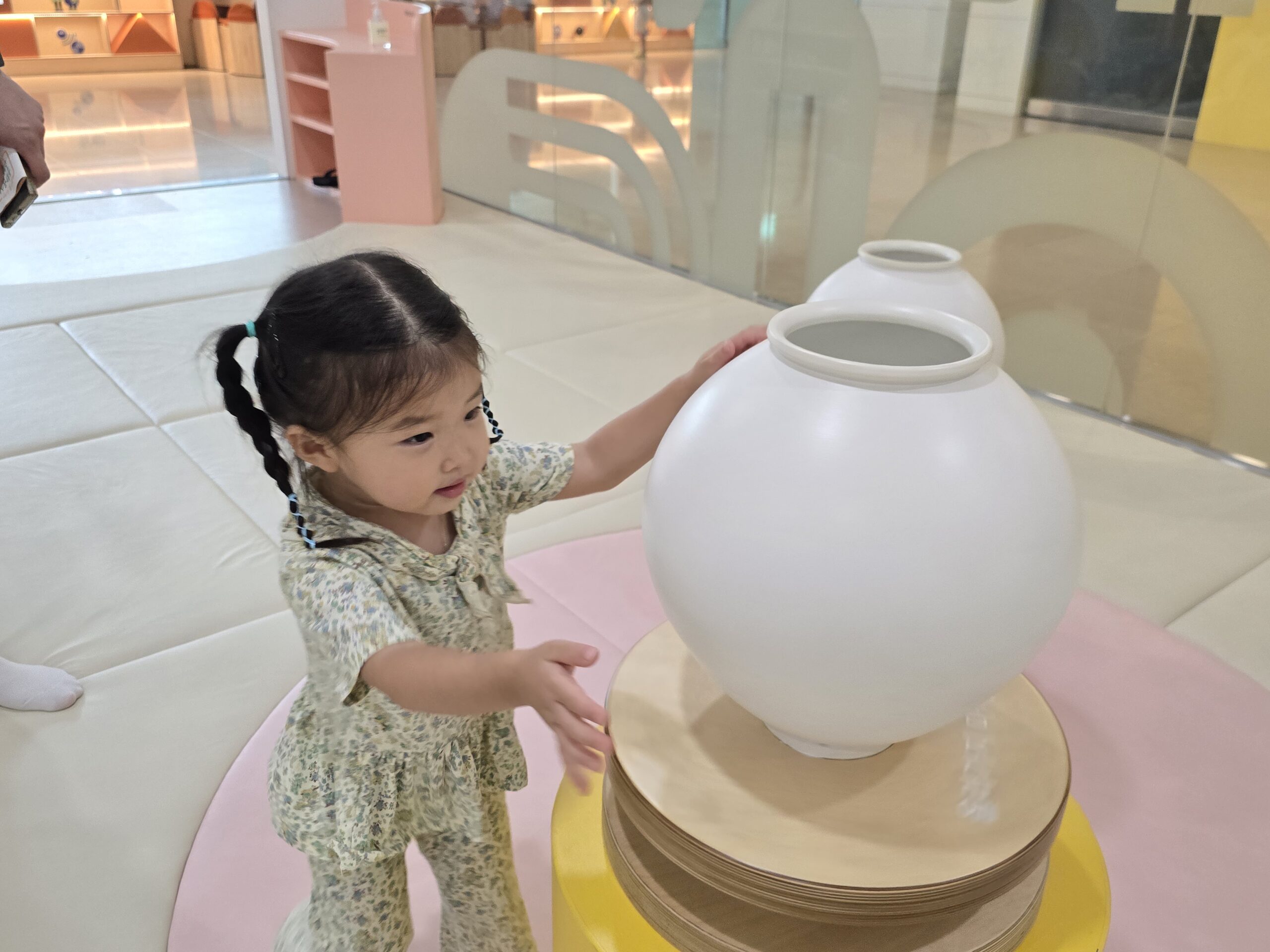 Toddler touching moon jar replica