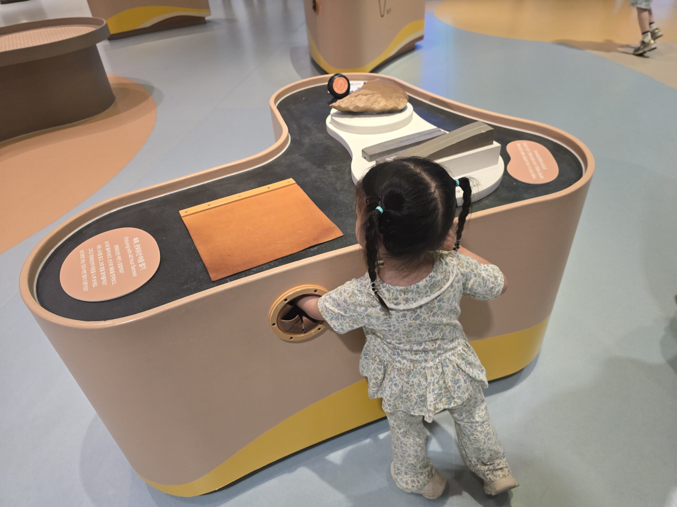 Child exploring interactive station in the exhibit