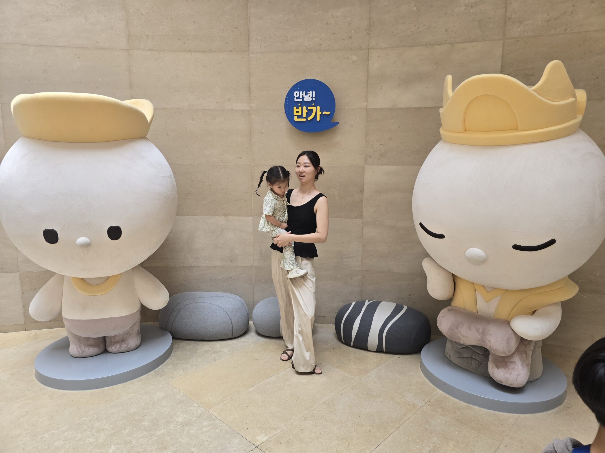 Pensive bodhisattva character statues photo spot — mom and child
