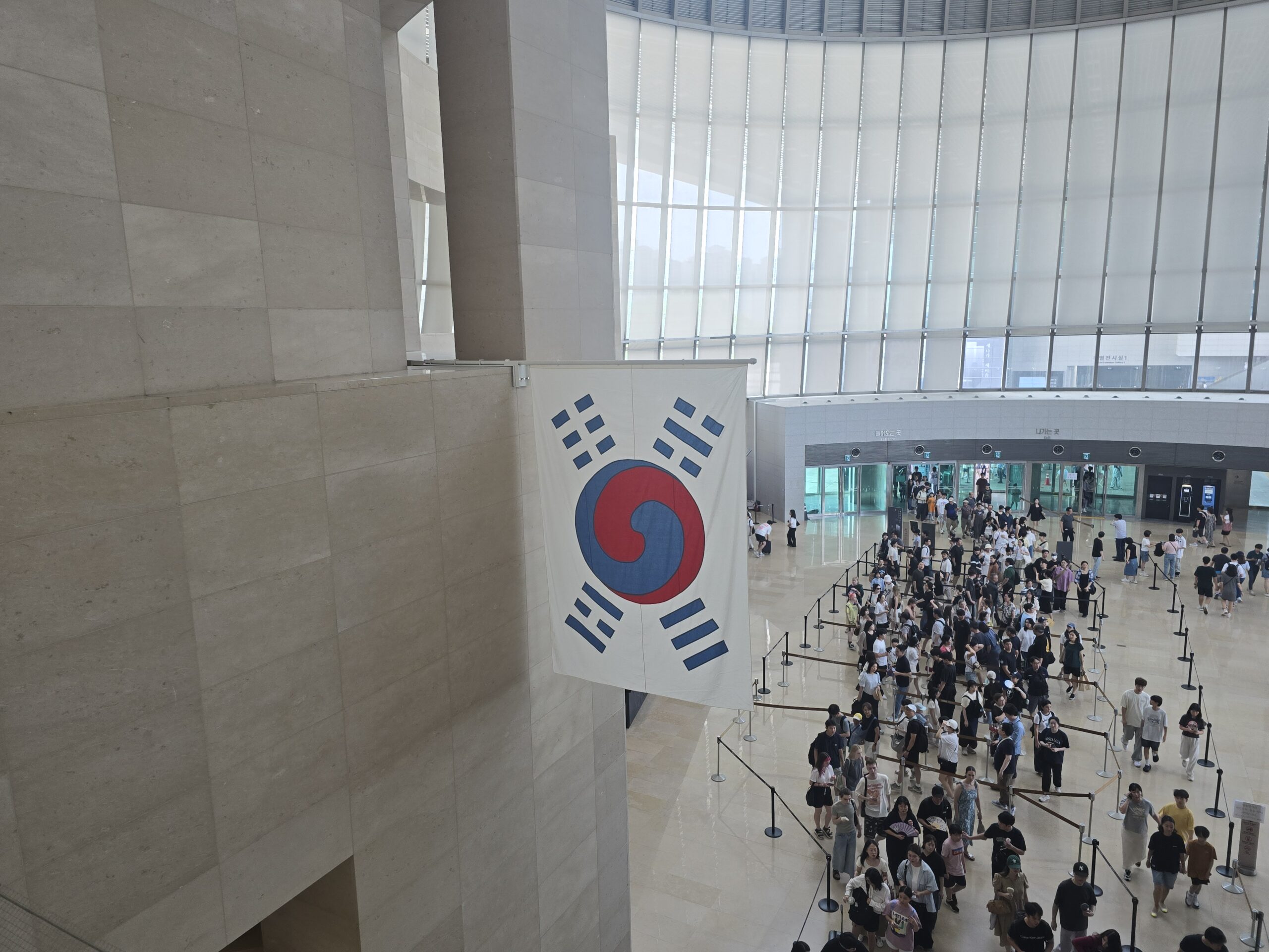 National Museum of Korea main lobby — Korean flag and visitors
