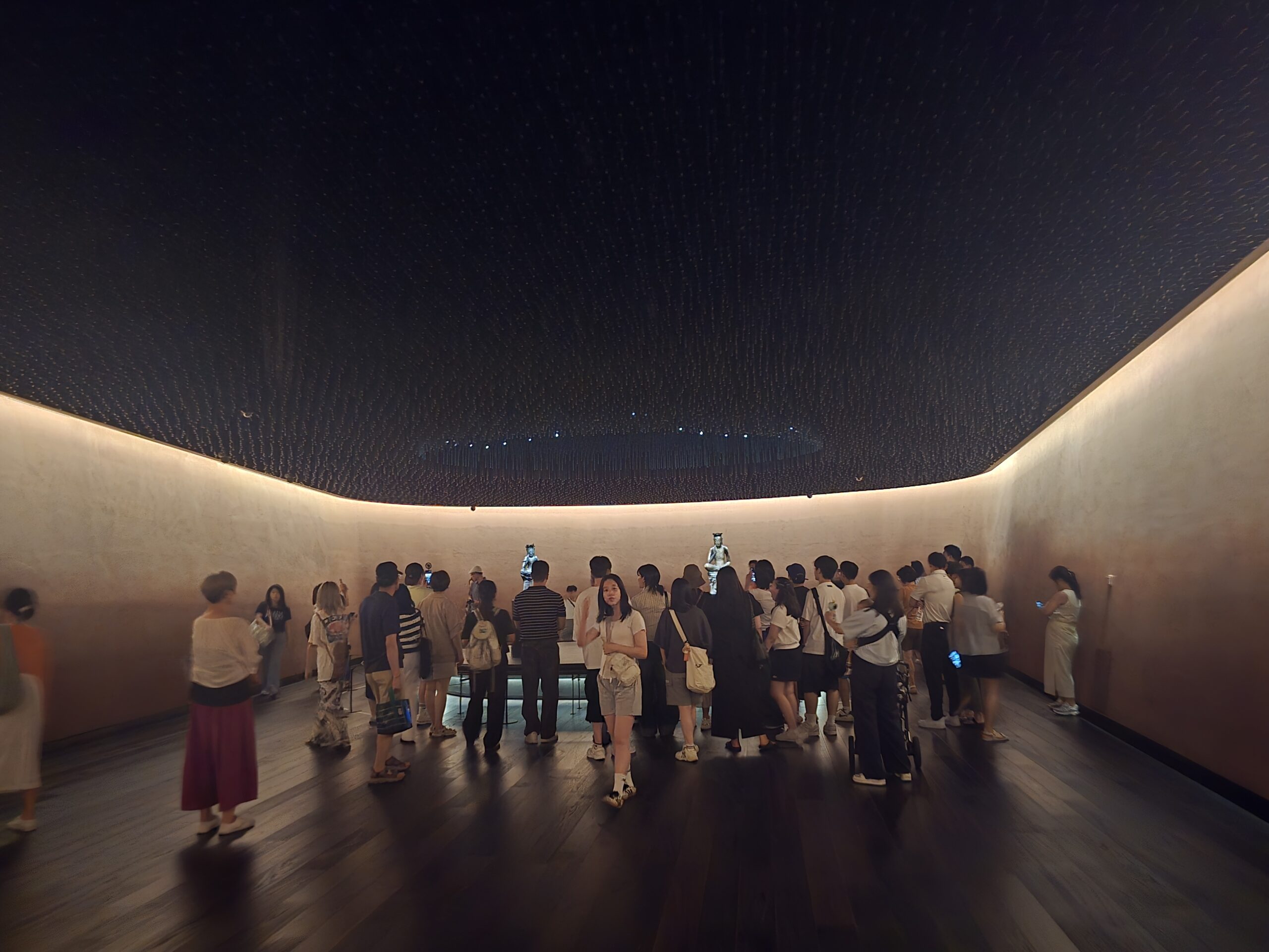 Room of Contemplation — visitors and two pensive bodhisattva statues