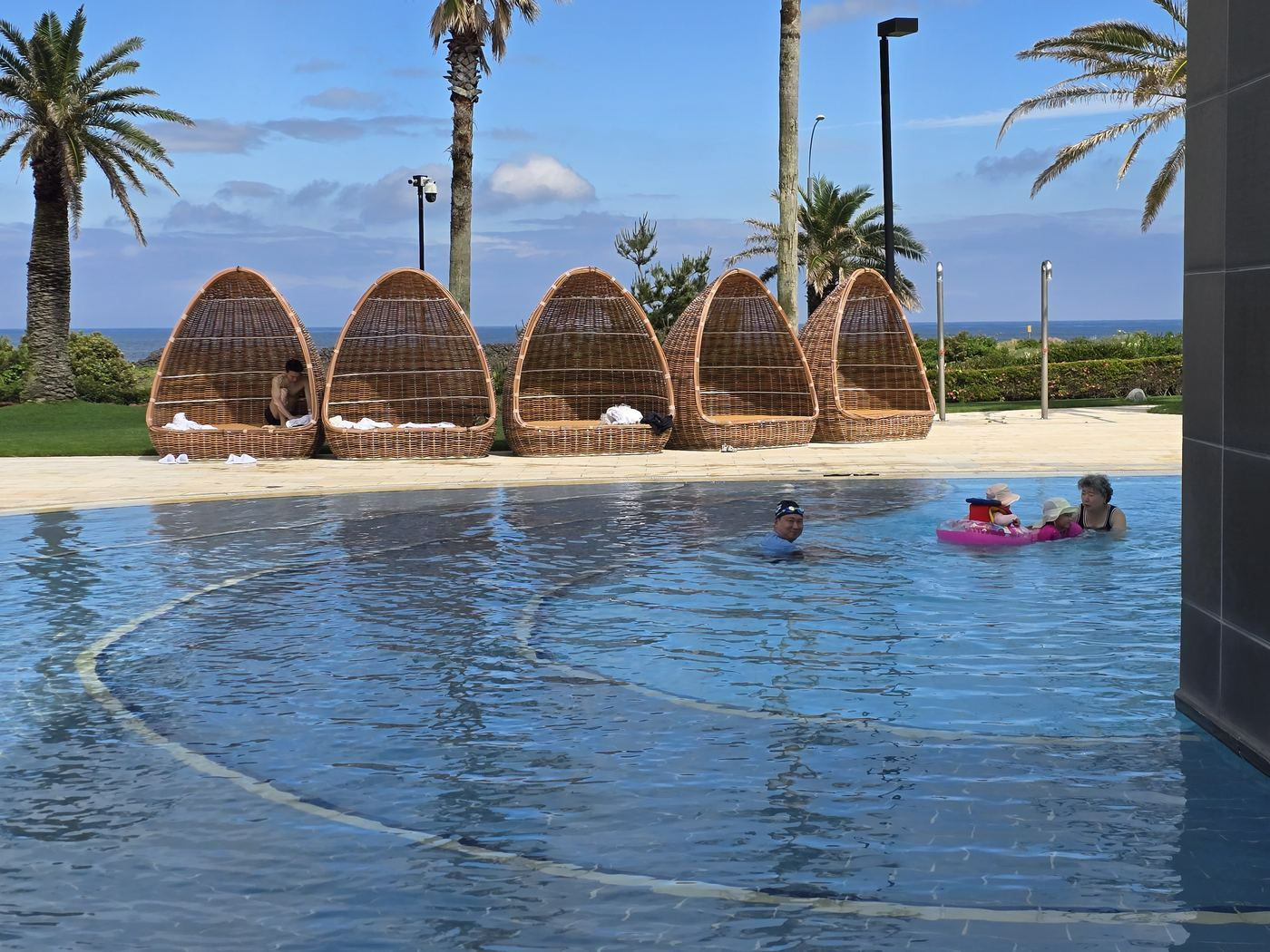 Haevichi outdoor pool at sunset with rattan loungers