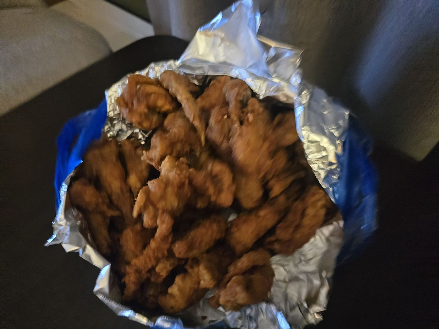 Delivered fried chicken in foil packaging