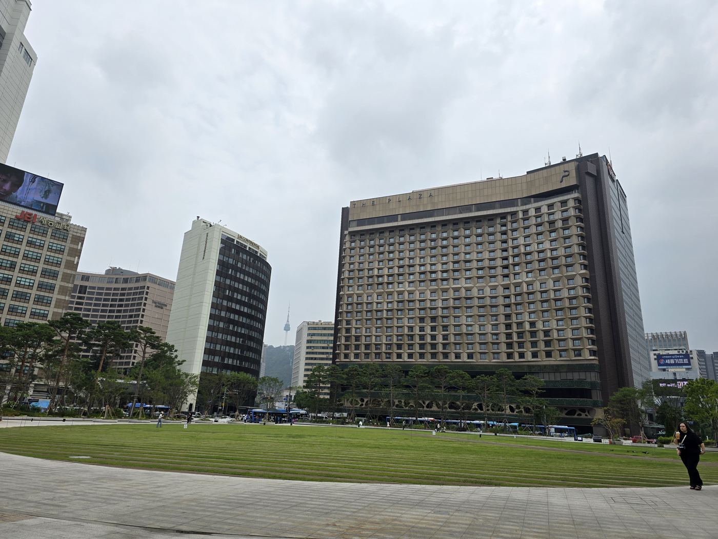 Seoul City Hall plaza with fountains and the iconic modern City Hall wave building behind the historic dome