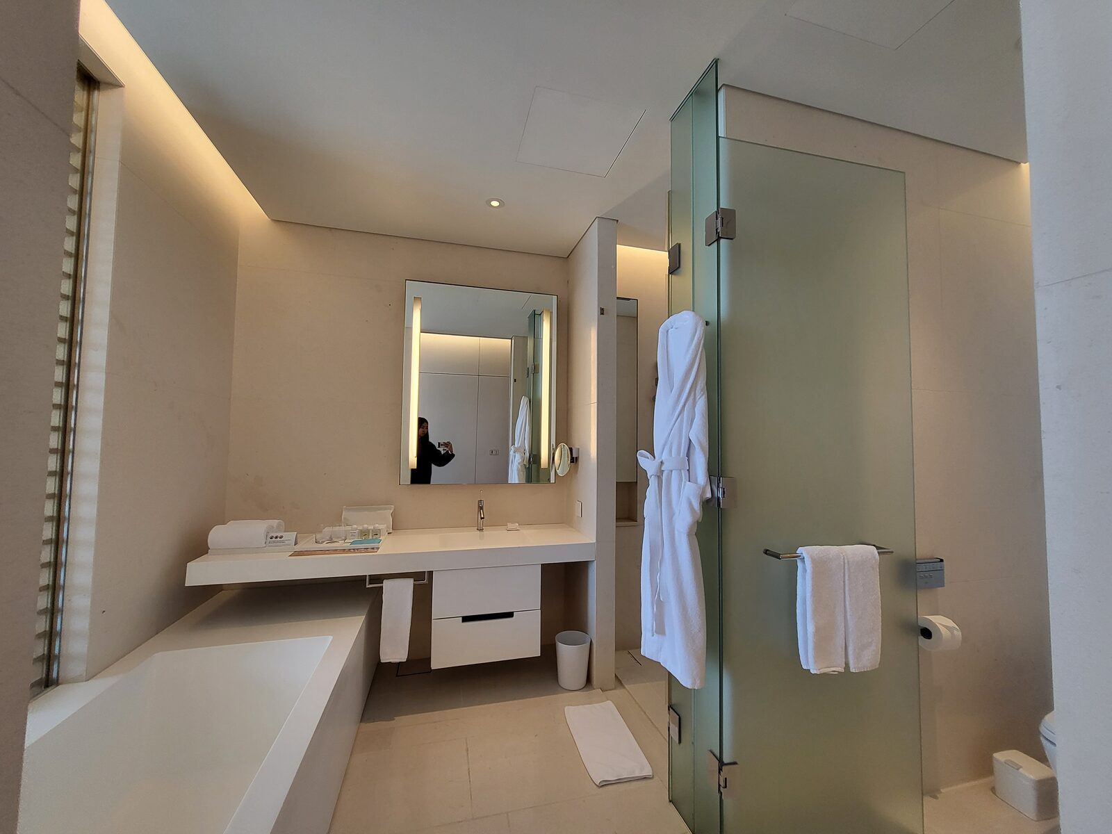 Bathroom with soaking tub, walk-in shower and robes at SEAMARQ Hotel Gangneung
