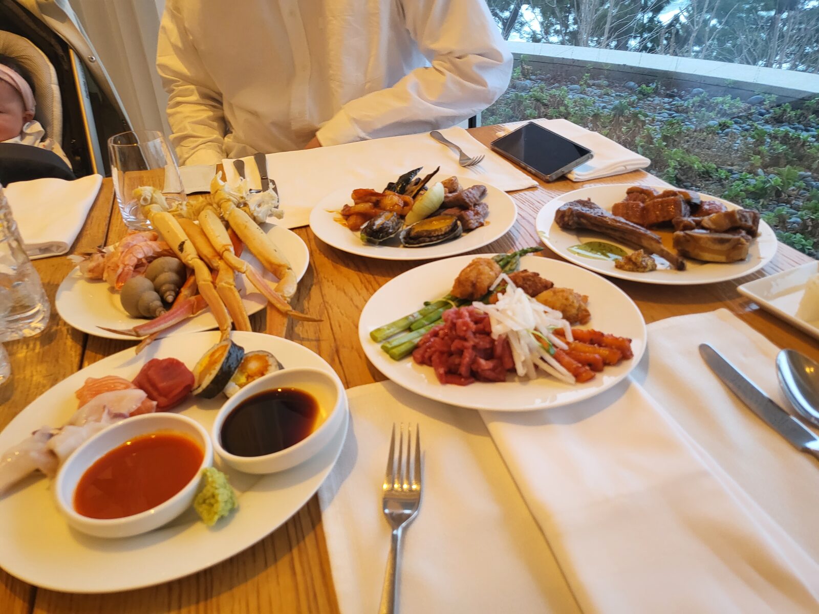 Buffet dinner spread at SEAMARQ Hotel Gangneung with a baby car seat at the table