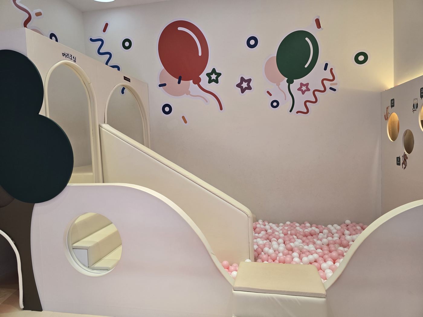 Kids room with ball pit and slide at Aqua Field Hanam