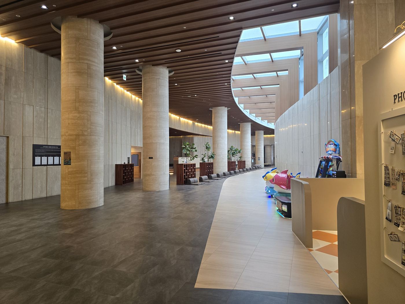 Aqua Field Hanam lobby with stone columns and skylight