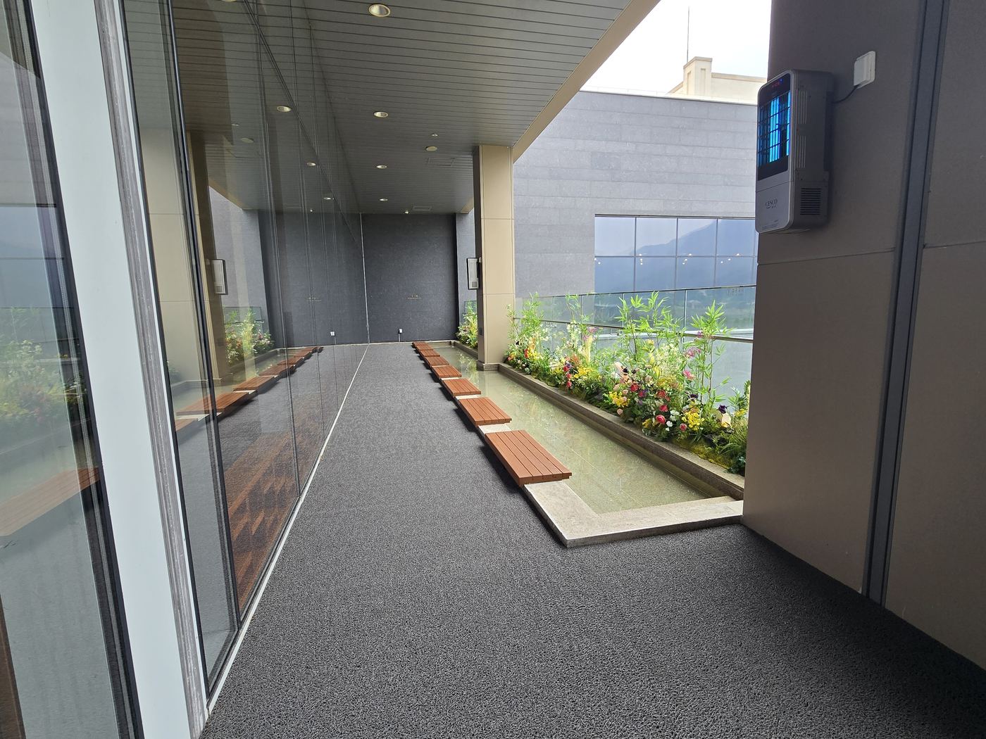 Outdoor foot spa walkway lined with flowers