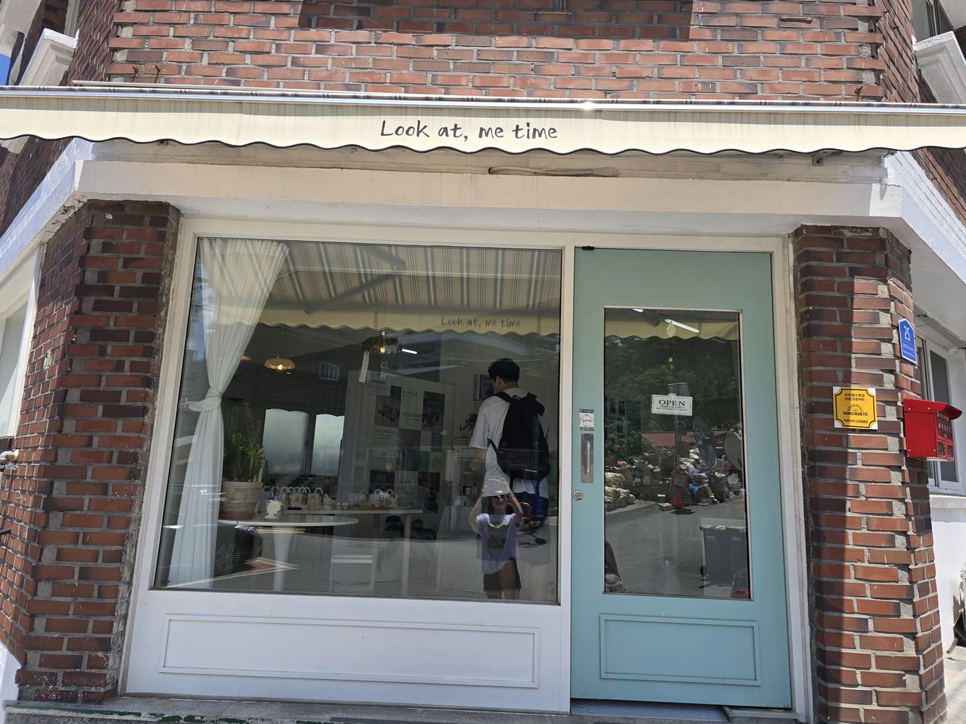 Look at Me Time exterior brick building