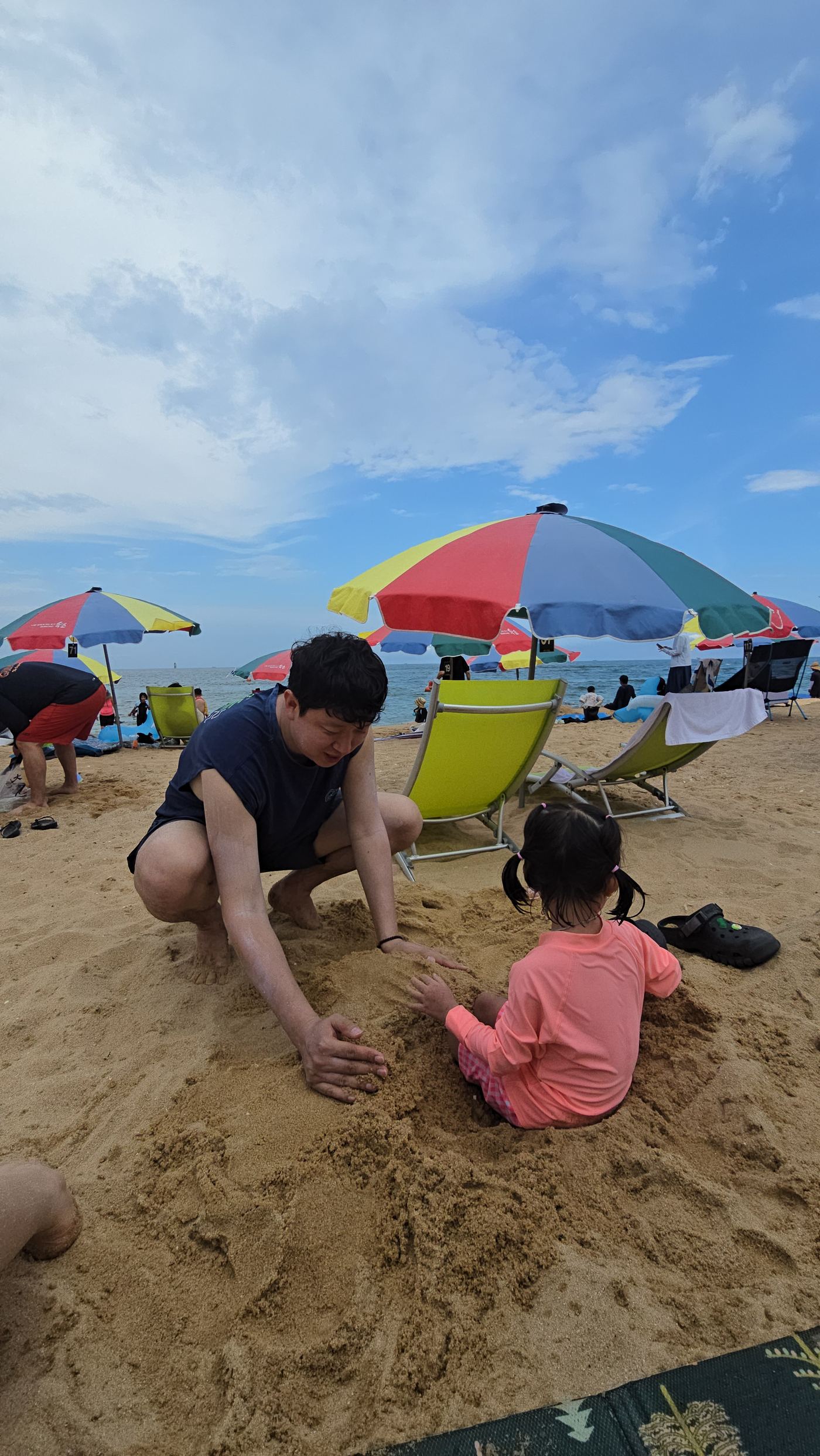 Dad and daughter playing in the sand at Sokcho Beach