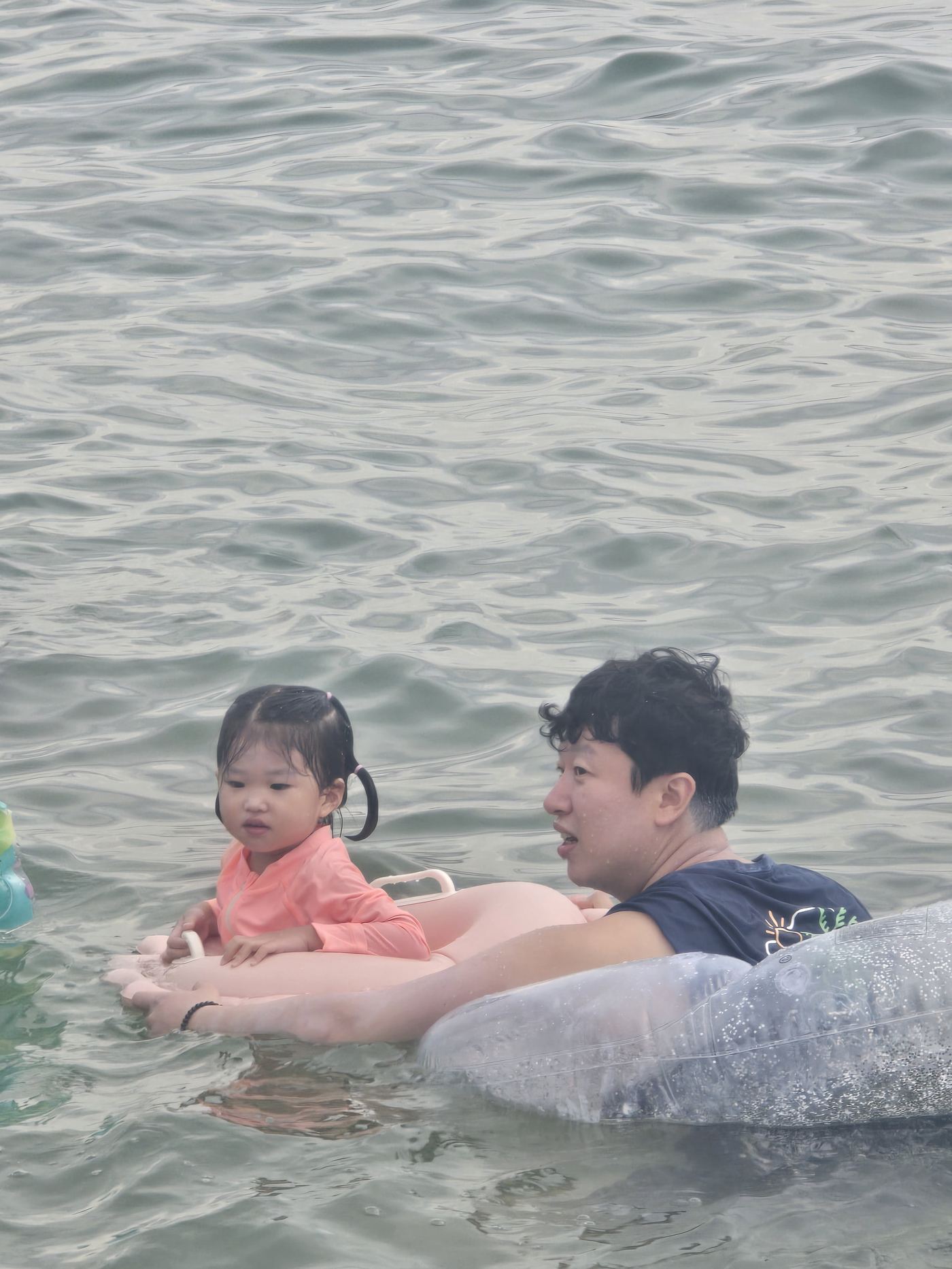 Dad and daughter playing in the water at Sokcho Beach