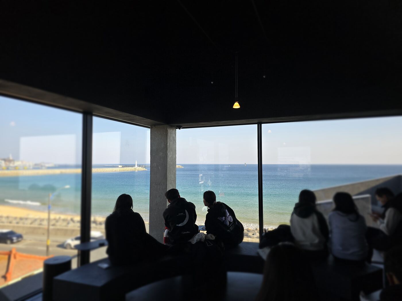 ARUNA café exterior Sokcho — white minimalist building with rooftop
