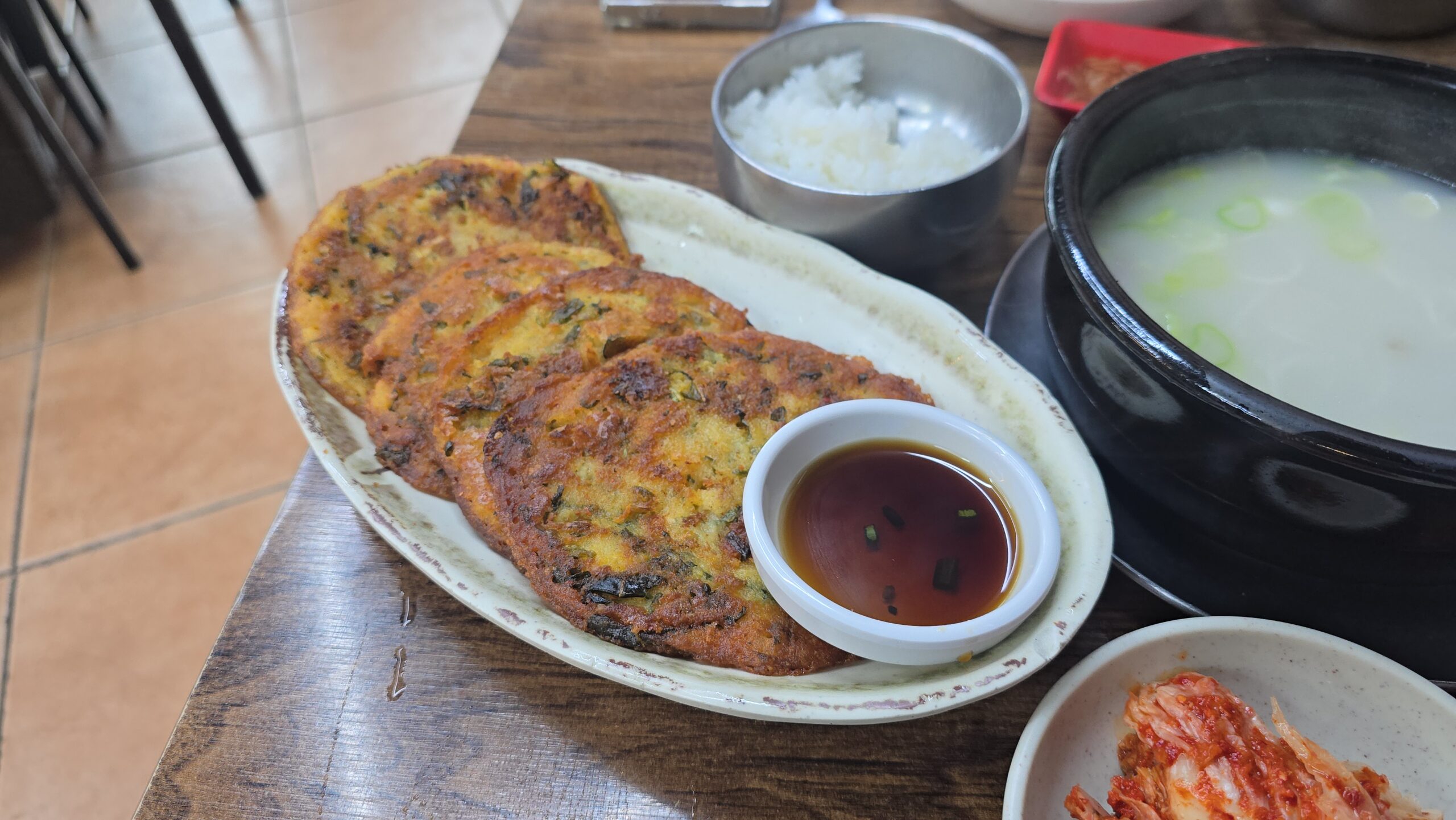 Korean mung bean pancake (bindaetteok) served with rice and soup in Jangchung-dong Seoul