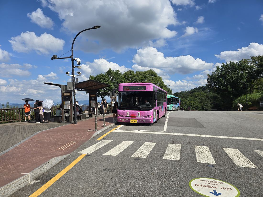 Family boarding the Namsan Circular Bus 01A to head back down