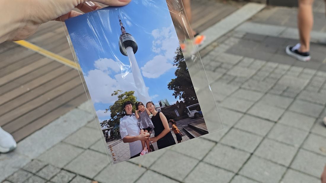 Printed family photo souvenir from N Seoul Tower