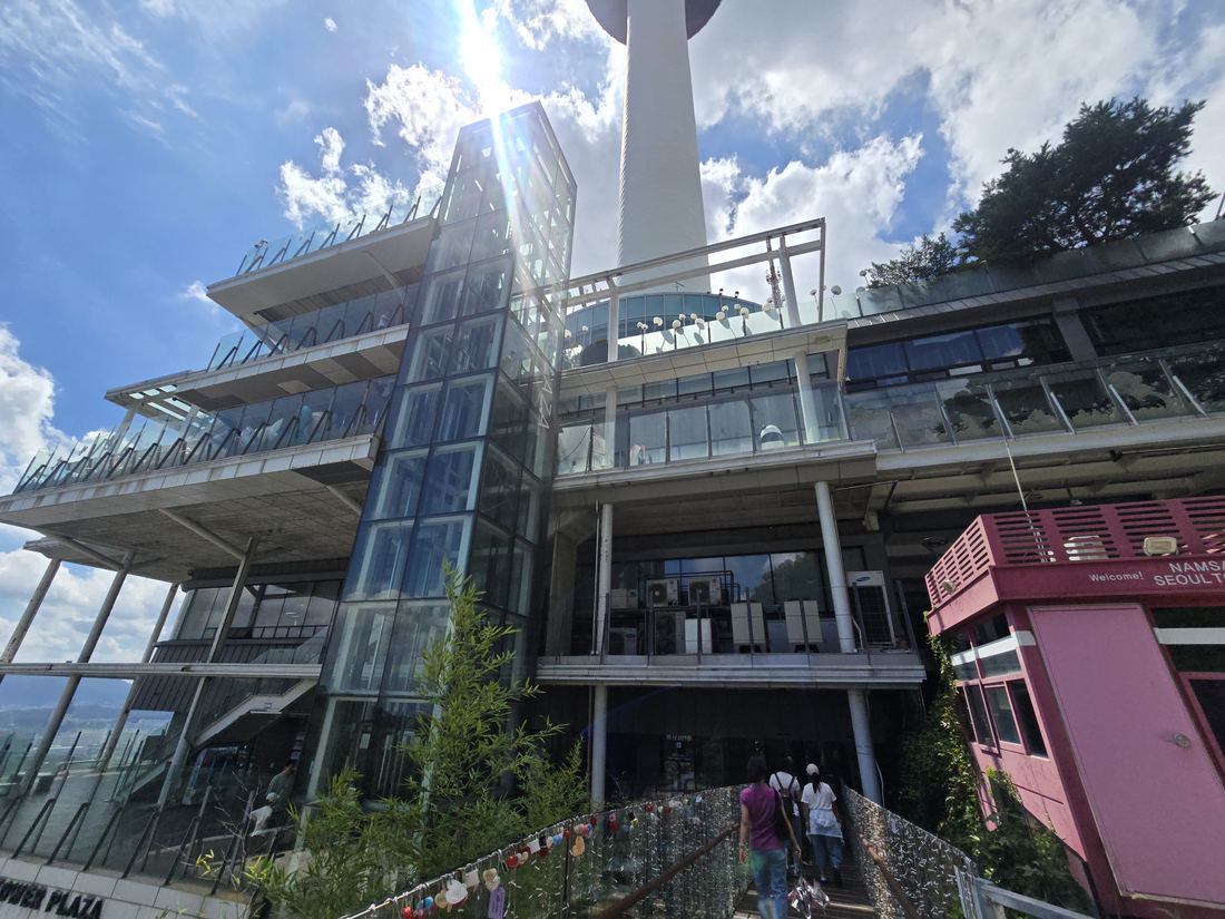 Looking up at N Seoul Tower with love locks at the base