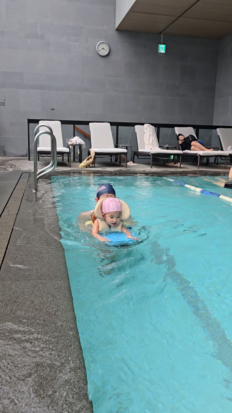 Toddler swimming with a flotation vest